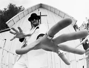 Kid Rock (who's coming to the Q) mistakes the camera for a stripper.
