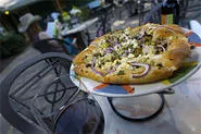 Mangiamo's leafy courtyard makes dishes like the vegetarian pizza even more pleasant. - PHOTO BY WALTER NOVAK