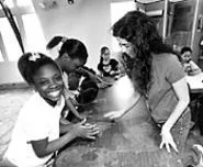 Osterland's classroom assistant Santina Protopapa - (right) helps Doniesha Kinney, Samantha Childs, and - Destiny Sutphin (from left) transform clay into art. - WALTER NOVAK