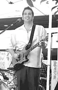 Patrick Sweany straps on his guitar and strums under - a bridge for paying customers at Saturday's Bridjazz.