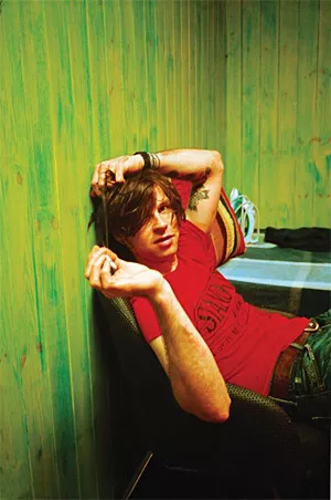 Ryan Adams fusses with his perfectly disheveled and totally indie hair.