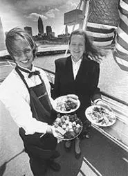 Ship of foods: Seafaring server Laura Spada (left) with Nautica Queen Restaurant Manager Roxane Dotson. - WALTER NOVAK