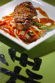 The Thai-inspired Satay Strip Steak, on a bed of onions and asparagus. - WALTER NOVAK