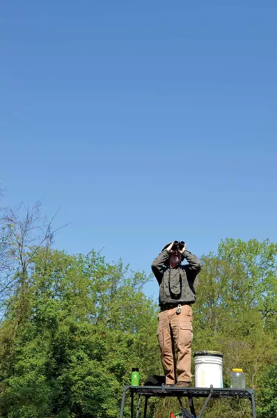 Tom Bartlett scans the skies for birds May 13 during the Biggest Week in American Birding. - PHOTO BY ERIC SANDY