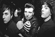 When not putting fans in headlocks, American - Werewolves frontman Trevor Moment (second from - right) is a bar bouncer and amateur martial-arts - practitioner. - WALTER NOVAK