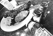 You can slide the sides onto a plate of superlative - baby-back ribs at Austin's. - WALTER NOVAK