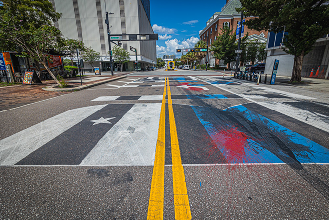 Red and black paint splashed all over the Back the Blue mural - DAVE DECKER