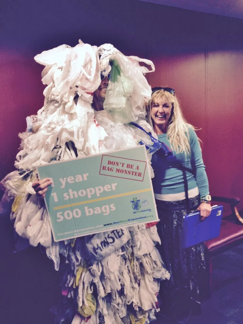 Ashley Workman of Tybee Island Resource Committee poses at the state capitol with the Plastic Bag Monster, aka Jim Ries of One More Generation.