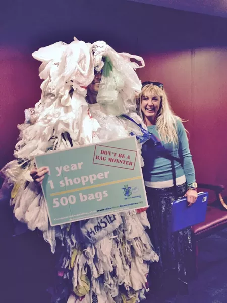 Ashley Workman of Tybee Island Resource Committee poses at the state capitol with the Plastic Bag Monster, aka Jim Ries of One More Generation.