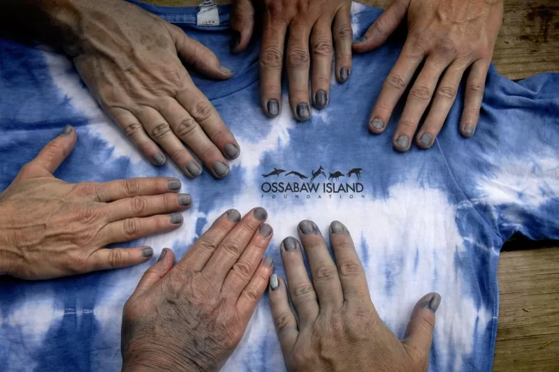 Blue fingertips are the telltale sign that these hands have been part of the indigo dyeing process. - ANN SOSBE