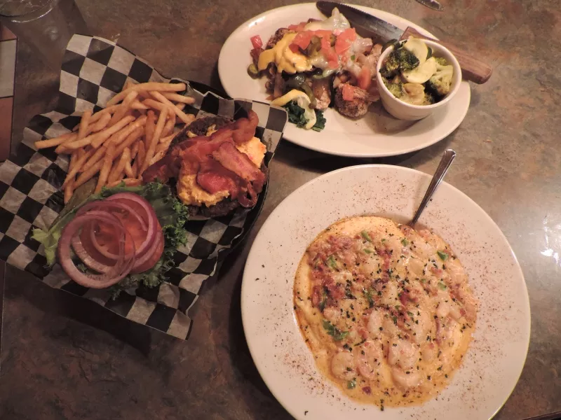 Clockwise from top right: ‘Junkyard Chicken’ with fresh veggies, creamy Shrimp & Grits, Sweet Tea Burger