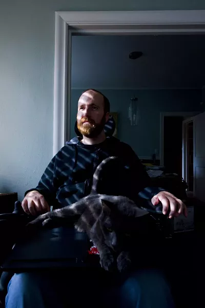 Jason Statts in his home. The local musician was shot in an armed robbery attempt in 2008. He remains paralyzed from the chest down. Photo by Geoff L. Johnson