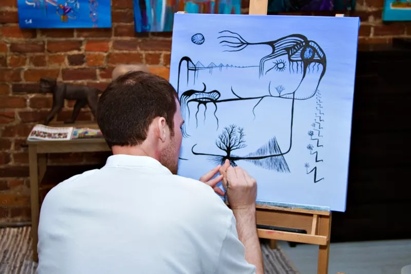 Jonathan G Keller in his City Market gallery and studio space during Savannah Art Walk. - NUNO SERRANO