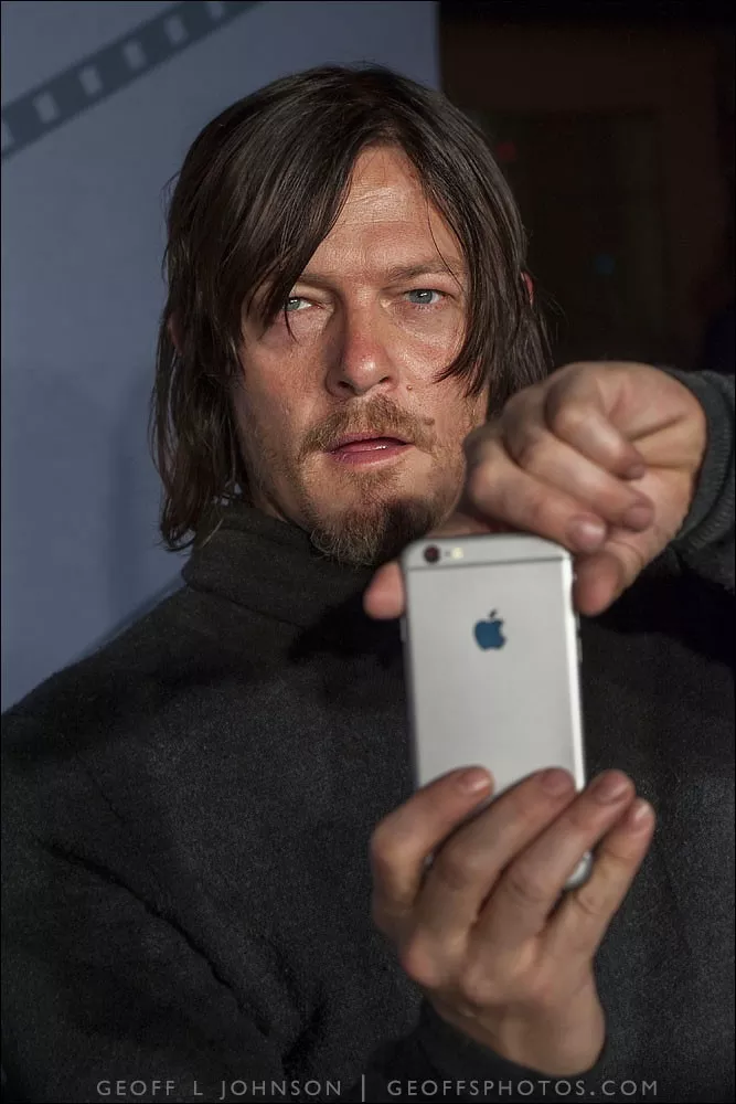 Norman Reedus turns the tables on photographers on the red carpet in front of Trustees Theater - GEOFF L. JOHNSON