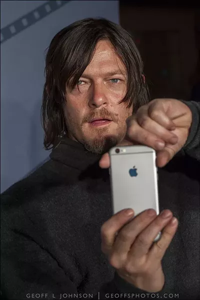 Norman Reedus turns the tables on photographers on the red carpet in front of Trustees Theater - GEOFF L. JOHNSON