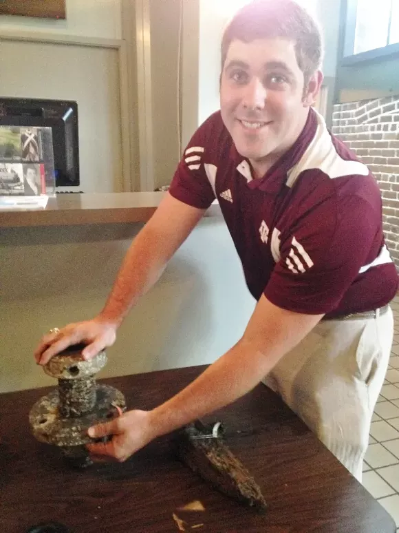 Conservator Parker Brooks shows off some of the finds from the CSS Georgia - PHOTOS COURTESY OF U.S. ARMY CORPS OF ENGINEERS, SAVANNAH DISTRICT.