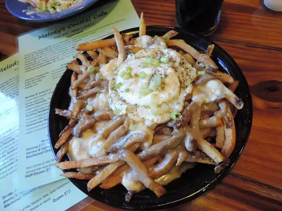 French-Canadian Poutine: hand-cut fries, topped with light gravy, fried pork belly, cheese curds, a fried egg & scallions--listed as an appetizer but definitely a meal!