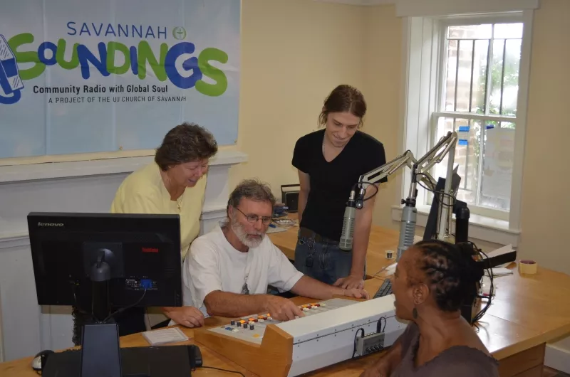 (L. to R.) Savannah Soundings project manager Vicki Weeks helps test the station’s new soundboard with program hosts Kevin Ionno and Mitchell Miller as Unitarian Universalist Church President Denise German looks on.