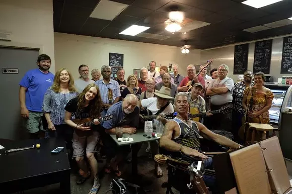 The gang’s all here! The Midtown Pickers gather every Wednesday at coffee.deli to enjoy tunes and an inspiring, family-friendly atmosphere. - PHOTO BY JERRY HARRIS