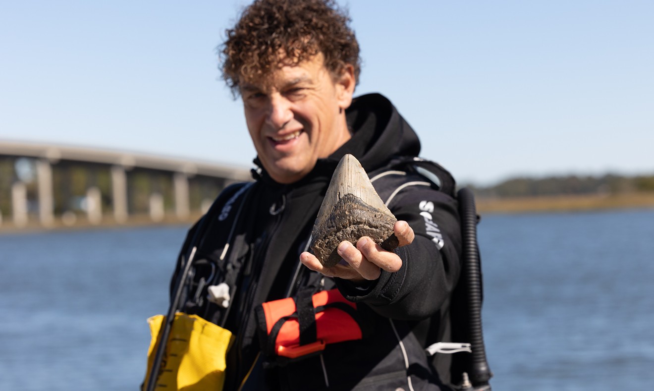 Bill Eberlein shows off a fossilized sharktooth he found while searching the rivers near Savannah.