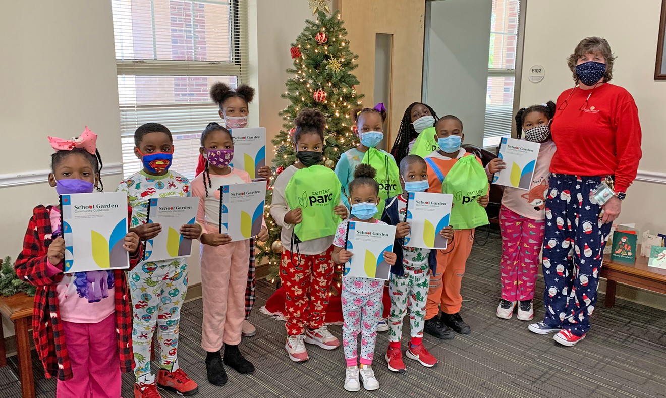 Students from Butler Elementary, one of garden-hosting schools that participated in the cookbook project, display the finished product, along with gifts from Center Parc Credit Union.