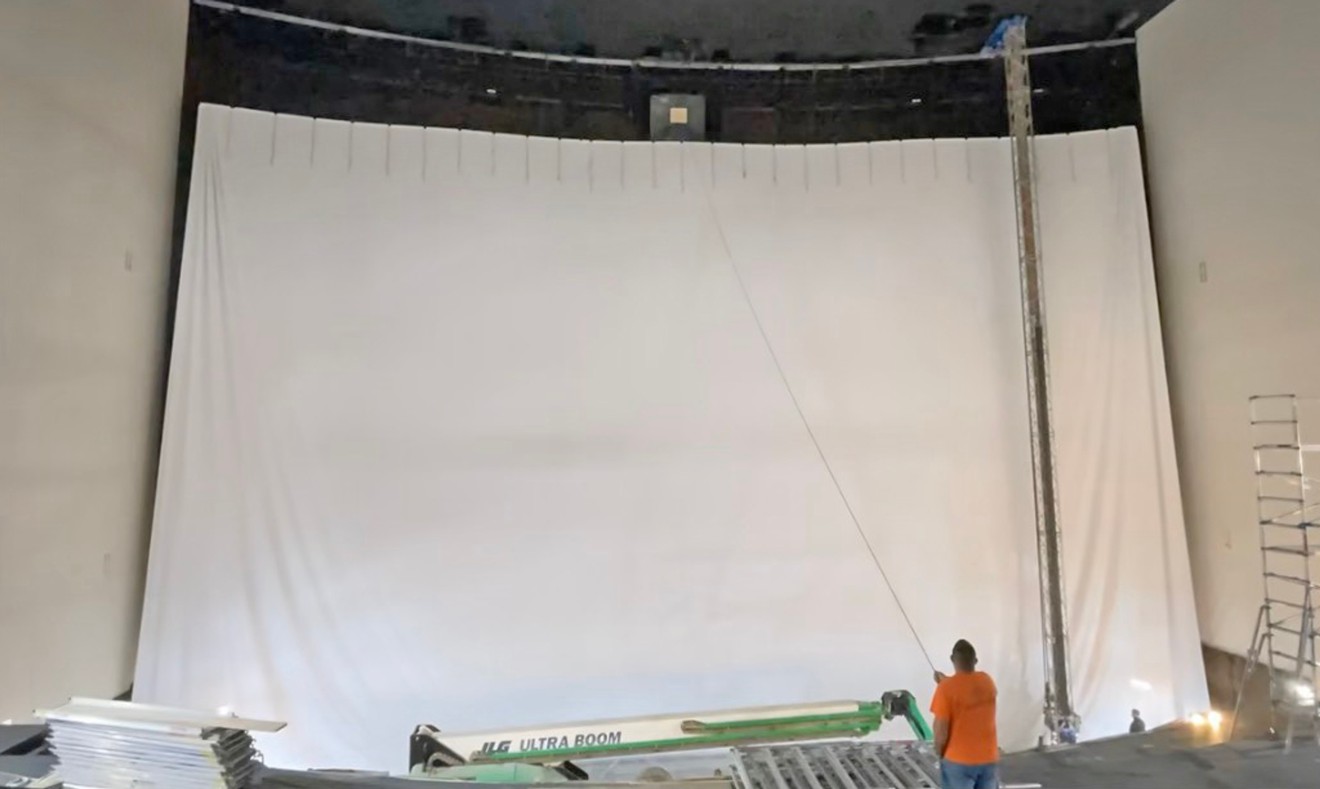 Workers raise the new IMAX screen at Pooler's Royal Cinemas.