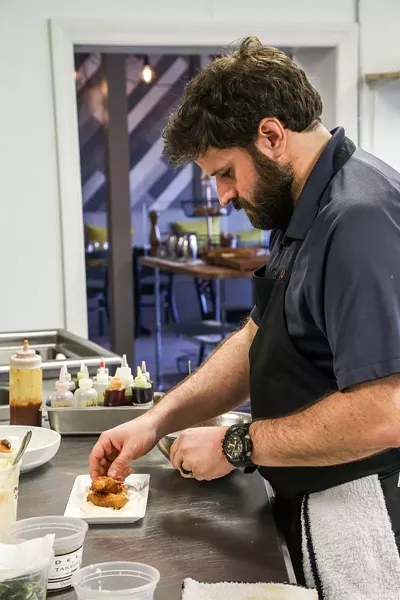 Chef Thomas plates up.
