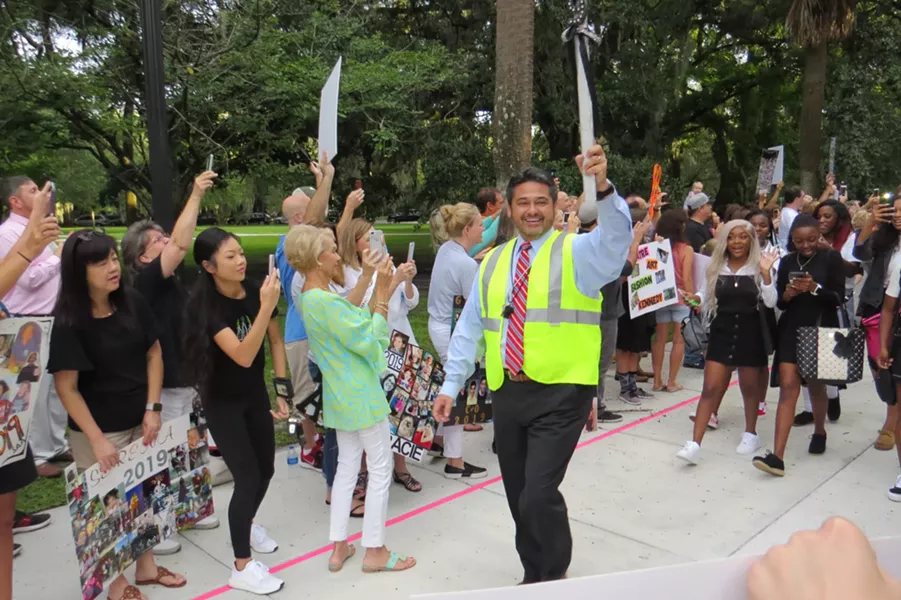 Gif Lockley (voted 2019 Connect Savannah Principal of the year) carrying a glittered scepter and leading the parade of seniors into their first day of school at Savannah Arts Academy (voted 2019 Connect Savannah Public School of the year).