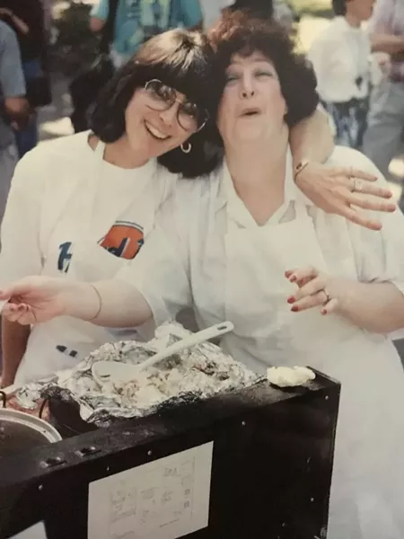 Volunteers Marcia Berens and Ava Gottlieb back in 1996, when the food festival was called "The Hard Lox Cafe." - COURTESY OF MICKVE ISRAEL