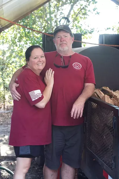 Roy and Mandy in front of their beloved smoker.