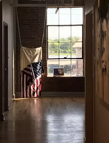 5. Untitled (Skinned), Installation view, variable, United States flags, bleach, sinew, chain, 2017
