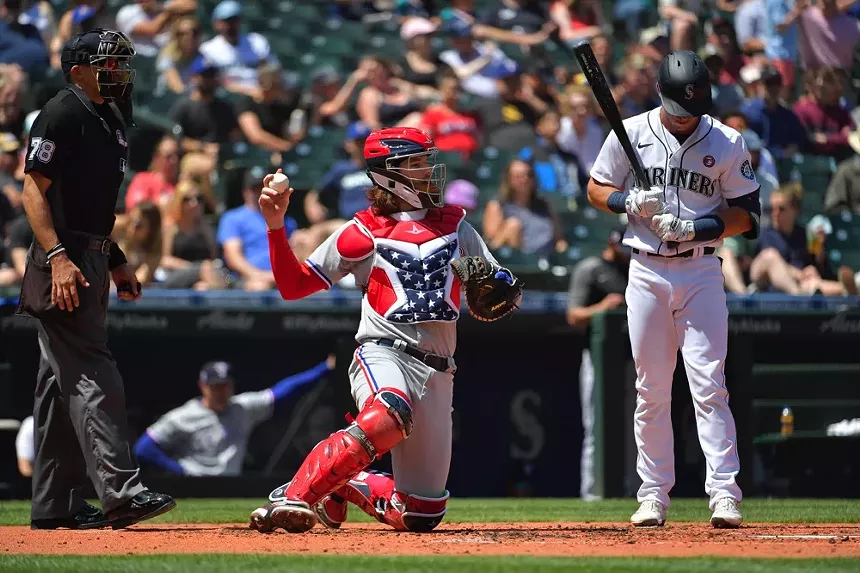 Jonah Heim works behind the plate in his 4th of July-themed gear during the third inning of the game against the Seattle Mariners at T-Mobile Park on July 4 in Seattle. - ALIKA JENNER/GETTY IMAGES