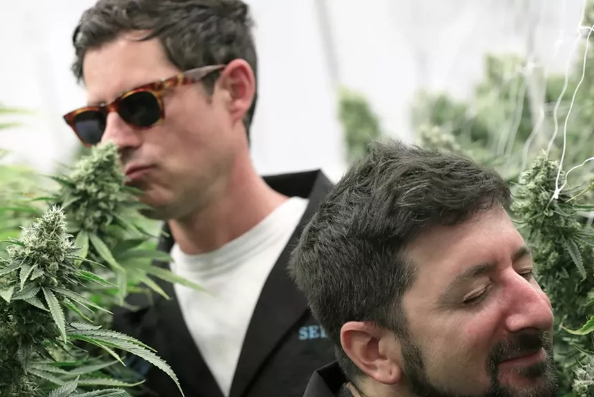 Big Gigantic's Dominic Lalli and Jermey Salken take in the scents of Seed & Smith's plants in anticipation of their collaboration with the company. - COURTESY OF SEED & SMITH