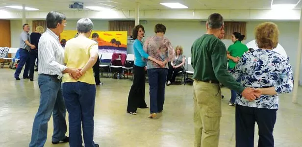 Kim Beachy demonstrating a new move at her Tuesday class in the Jerome Methodist Church basement. - PHOTOS BY PATRICK YEAGLE