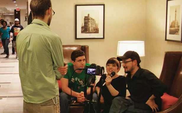 Jones, right, gives an interview in a quiet corridor at an Indianapolis convention along with Sarah Lewis and Ed Glaser, who appear in his productions. - PHOTO BY BRUCE RUSHTON