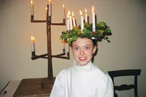 Bishop Hill celebrates its Swedish heritage with annual Saint Lucia Nights or Festival of Lights. Young girls such as Whitney Johnson wear crowns of lighted candles and serve sweets to visitors in museums and shops throughout the village. This year�� - PHOTO COURTESY OF BISHOP HILL STATE HISTORIC SITE
