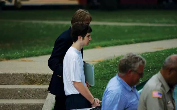 Terry Payton is led into the Edgar County Courthouse by law enforcement officers on July 18. - PHOTO BY PATRICK YEAGLE