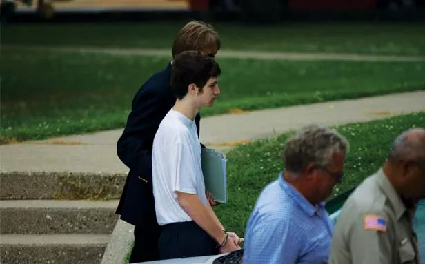 Terry Payton, charged with murdering his mother, is led into the Edgar County Courthouse by law enforcement officers on July 18. - PHOTO BY PATRICK YEAGLE