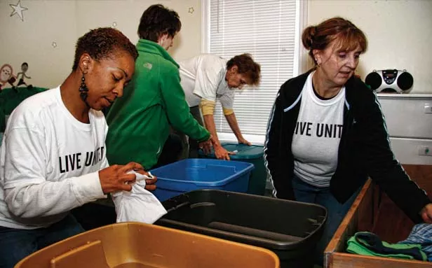 Volunteers Tameka Rushin (left) and Lori Batchelder (right) sort children’s clothes at Mini O’Beirne Crisis Nursery, 1011 N. Seventh St.