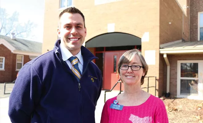 James Hayes, Harvard Park Elementary principal, and Peggy Cormeny, family and community engagement coordinator for Springfield Public Schools, appear outside the school, which recently hosted an event helping families enroll in health insurance. - PHOTO BY PATRICK YEAGLE