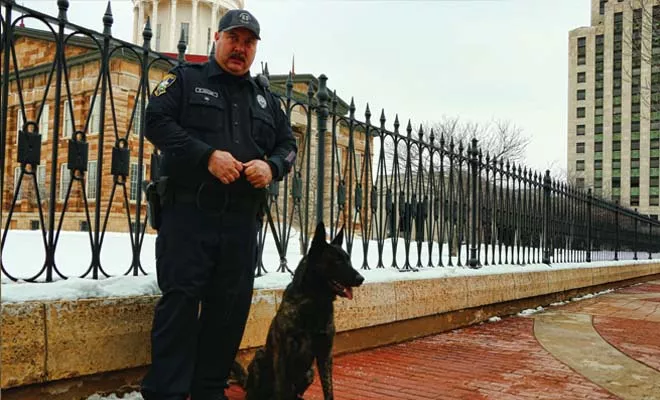 Springfield patrol officer Ron Howard is head of the Springfield Police Department’s drug dog unit. He’s shown here with his dog, Jax. - PHOTO BY PATRICK YEAGLE