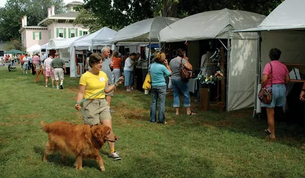 Betsy Dollar with her dog, Truman, checking out the Sept. 18 Fine Arts Fair, a major annual event held each fall on the SAA grounds. - PHOTO BY GINNY LEE