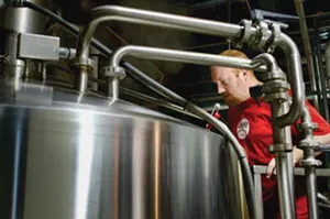 A brewer at Schlafly Bottleworks checks on a batch of its Pale Ale in Maplewood, MO. - PHOTO BY HUY RICHARD MACH/TNS