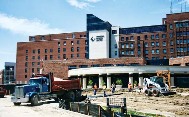 A construction crew prepares to pour a large concrete pad that will support a tall construction crane in the coming weeks at Memorial Medical Center’s main entrance facing south. - PHOTO BY PATRICK YEAGLE