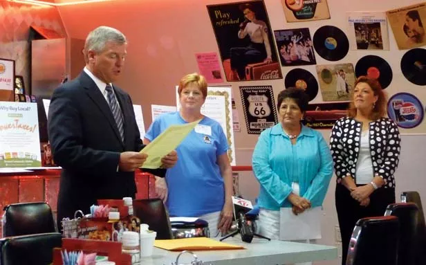 Illinois Times publisher Sharon Whalen, second from left, as the late Mayor Tim Davlin proclaims “Independents Week” for the Capital Area Independent Business Association in July 2009. At right are Rosemarie Long and Debbie Cimaros