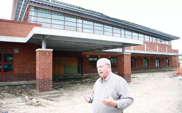 Dave Smith, director of operations and maintenance for School District 186, leads a tour of the new Matheny-Withrow Elementary School, which features a community room. - PHOTO BY PATRICK YEAGLE