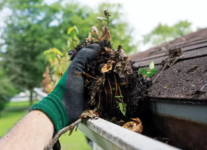 Cleaning gutters and downspouts helps prevent basement moisture and seepage. - PHOTO BY ISTOCKPHOTO.COM