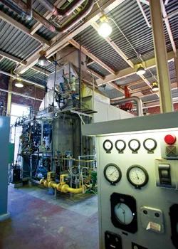 The natural gas and fuel oil boilers, added in 1973, inside the Capitol power plant. Though cleaner than coal, the gas units are more costly to run and therefore only fired up for testing or when the coal boilers are down for maintenance. - PHOTO BY JONATHAN KIRSHNER