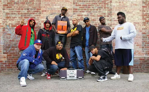 Performers, left to right: Tebe Zalango, MC R-Two, DJKT, Rikashay (holding the sign), Howard “Torch” Tomas, Bis, Rashid, Boby Fishr, Mr. Myles and Cornbread. - PHOTO BY DAVID HINE
