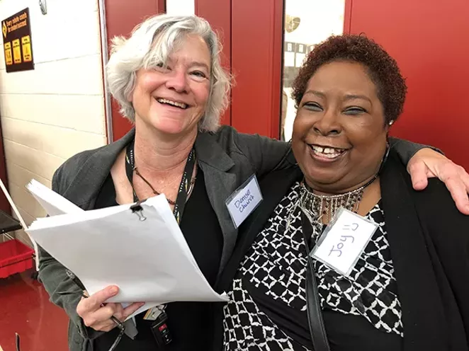 Joy Burgess, right, chief organizer of the expungement summit, works at the Land of Lincoln Legal Assistance Foundation, but also did it as a labor of love. “Oh my God it feels good to be able to help people,” she said. Denise Church, left, a - PHOTO BY FLETCHER FARRAR